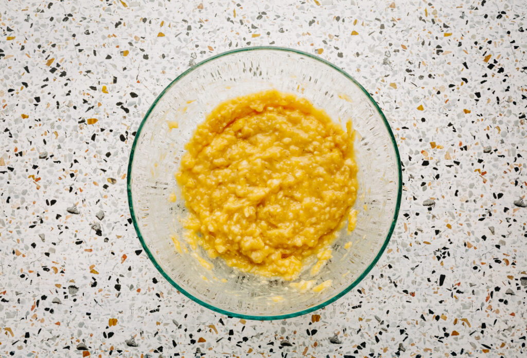A bowl of freshly mashed bananas, the base for a clean-label mini muffin recipe made without seed oils or processed dyes.