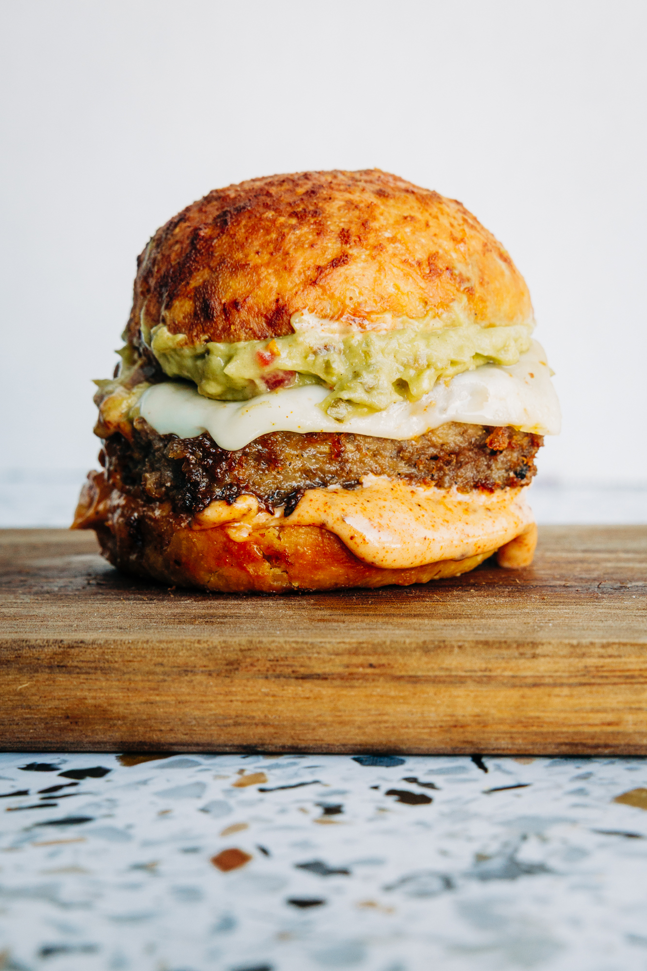 Copycat Chili’s Santa Fe burger sliders featuring juicy beef, melted cheese, homemade guac, and signature sauce.