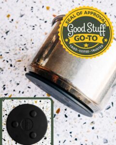 Lodge magnetic trivet attached to the bottom of a stainless steel pot on a clean kitchen counter.