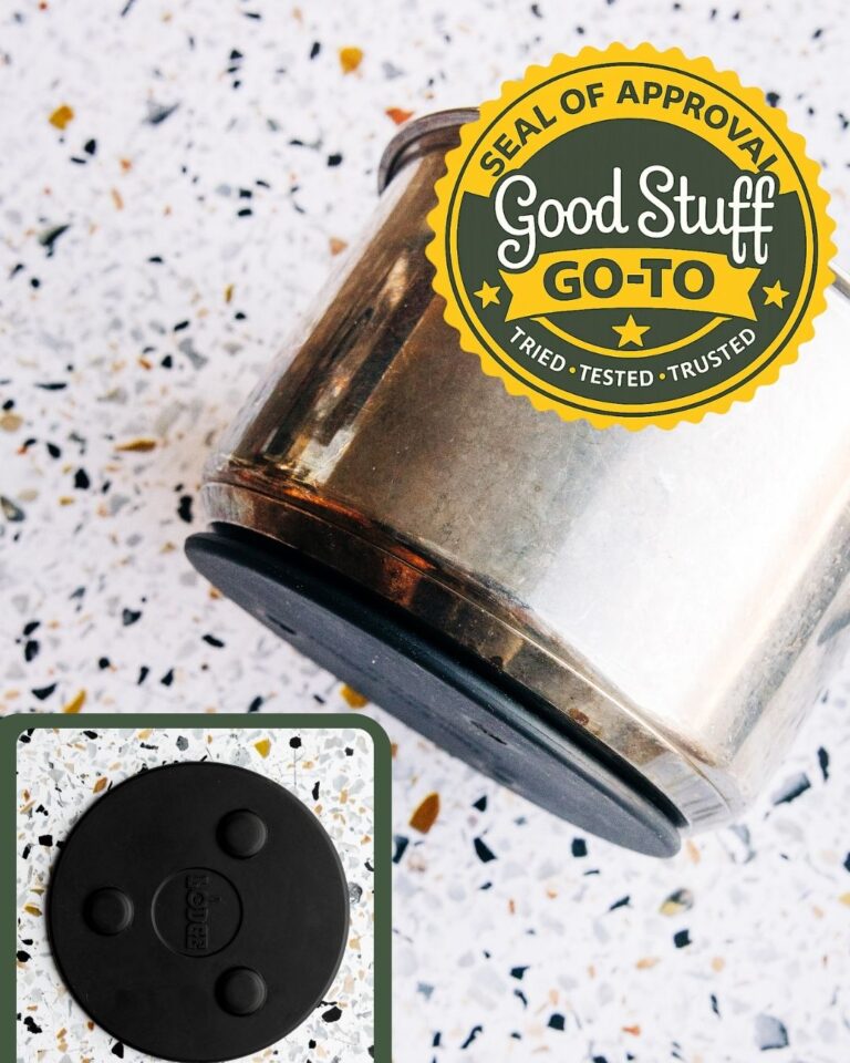 Lodge magnetic trivet attached to the bottom of a stainless steel pot on a clean kitchen counter.