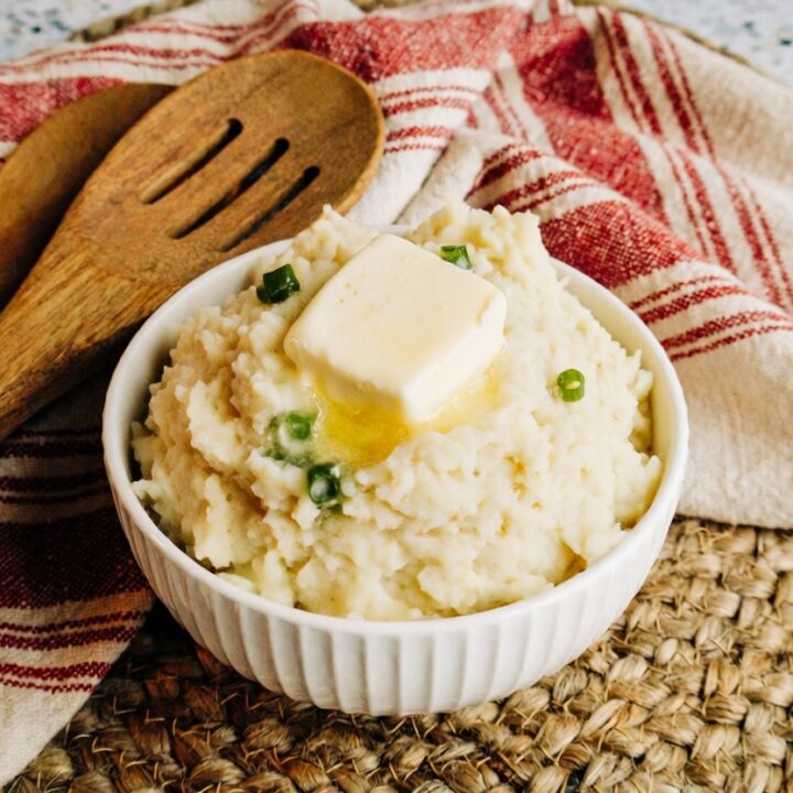 creamy mashed potatoes made in an instant pot and topped with chives and butter
