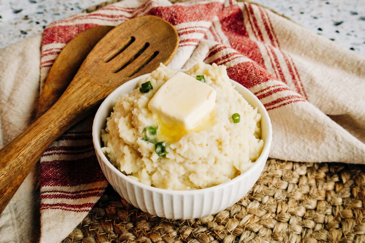 creamy mashed potatoes made in an instant pot and topped with chives and butter
