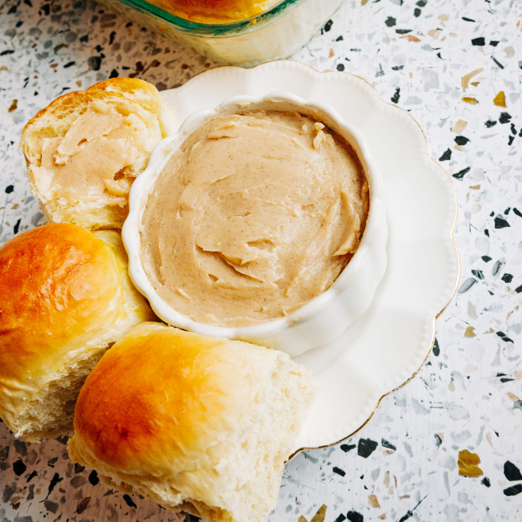 texas roadhouse style butter next to homemade rolls 