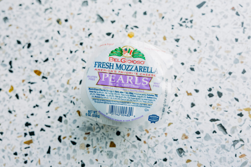 fresh mozzarella pearls ready to go on a cucumber avocado salad