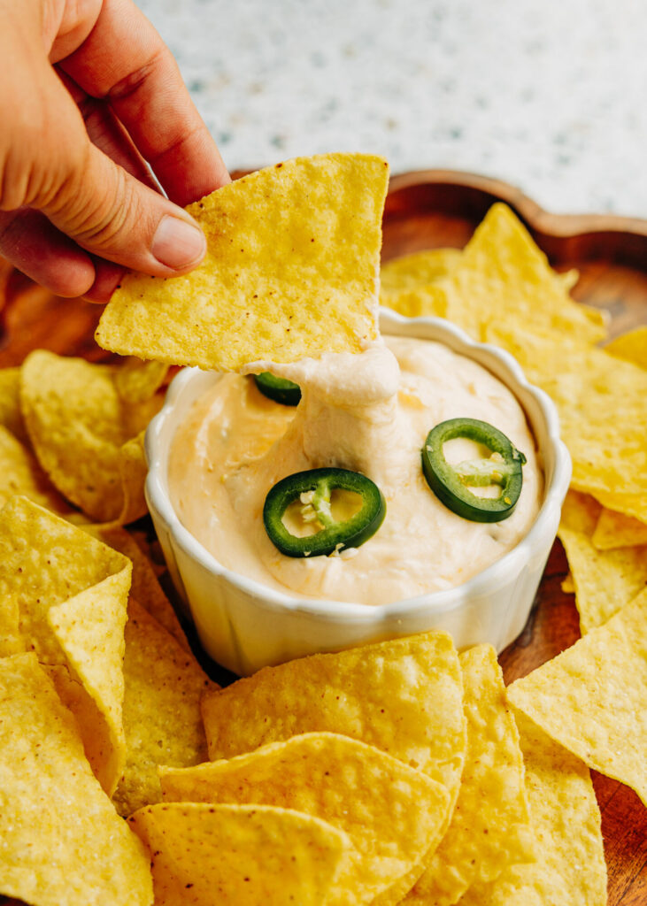 a jalapeno popper dip garnished with sliced jalapeños. Served with tortilla chips.