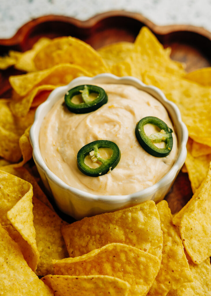 gluten free jalapeño popper dip surrounded by tortilla chips 